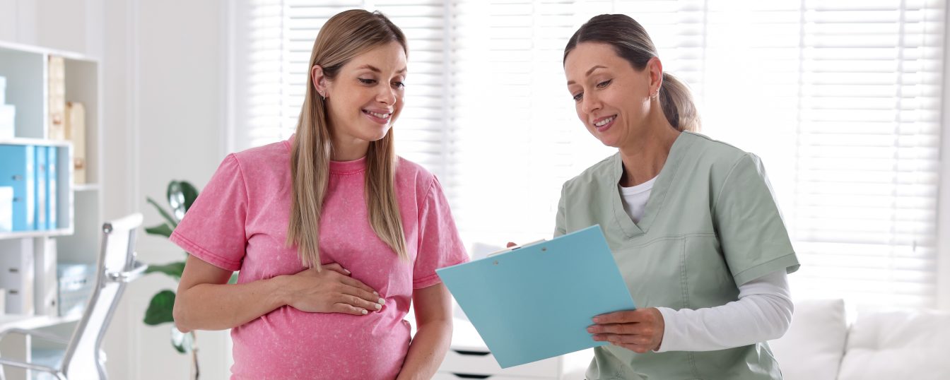 Pregnant woman having appointment with doctor in clinic